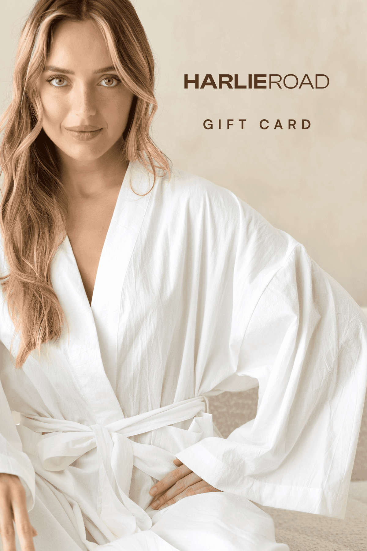 Woman in a white robe with 'Harlie Road' gift card text on a beige background