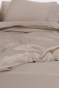 Rose dust bedding set with pillows on a white background